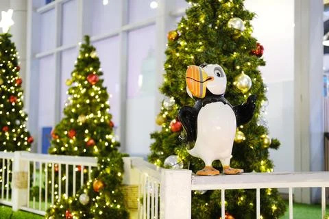 Festive decor featuring a whimsical bird statue surrounded by beautifully Stock Photos