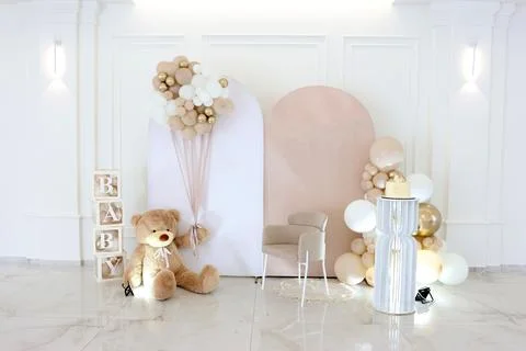 Festive decor with a large teddy bear, BABY blocks and balloon cluster for a  Stock Photos