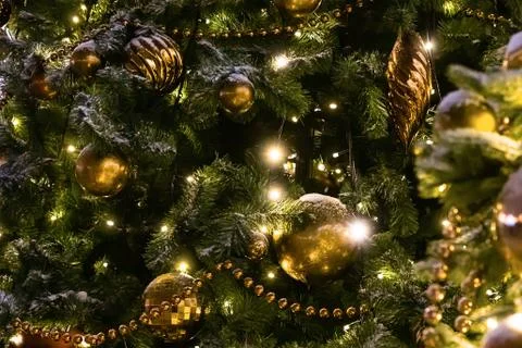 Festive decor pattern decorated christmas tree with balls, beads and garland Stock Photos