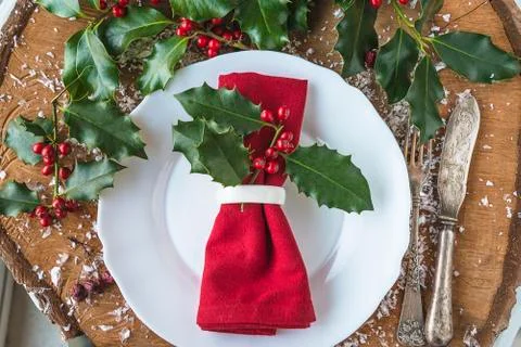 Festive decorated table setting. Red napkin with ring, vintage fork and knife Stock Photos