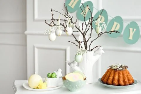Festive decoration of the Easter table, a vase with a branch and decorations Stock Photos