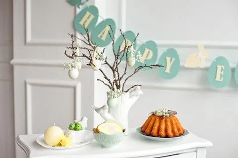 Festive decoration of the Easter table, a vase with a branch and decorations Stock Photos