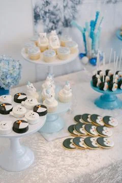 Festive dessert table featuring winter-themed cupcakes and cookies for a cozy Stock Photos