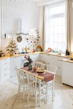 Festive dining table in a cozy kitchen featuring a pie and centerpiece Stock Photos