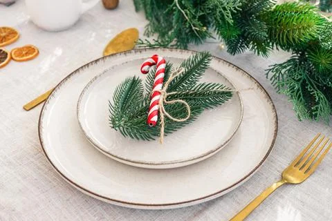 Festive dining table setting with greenery and seasonal Christmas decoratio.. Stock Photos