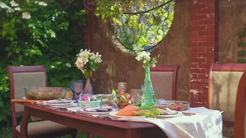 Festive dinner, Easter brunch on the terrace in the garden. Traditional Easter Stock Footage 237536447