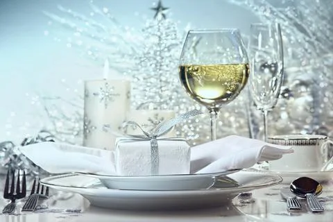 Festive dinner setting with gift for the holidays Stock Photos