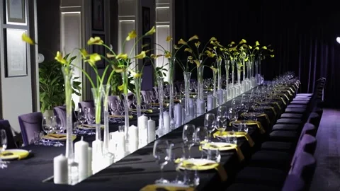 Festive dinner table served with dishware and decorated with yellow flowers Stock-Footage 263729094