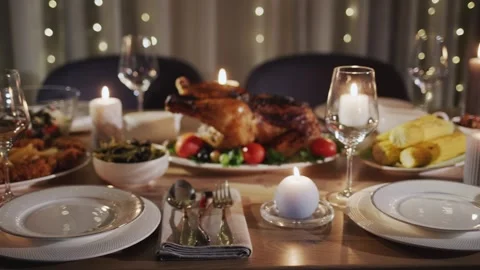 Festive dinner table set with roasted turkey, side dishes, candles and wine.. Stock Footage 334843978