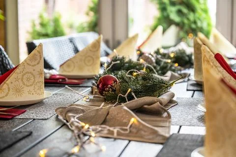 Festive dinner table setting decoration for christmas with Paper, lights Stock Photos