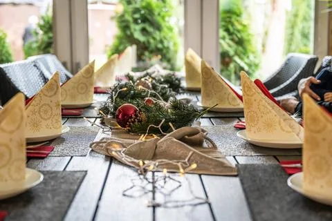 Festive dinner table setting decoration for christmas with Paper, lights Stock Photos