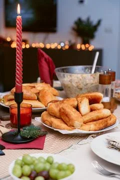 Festive Dinner Table with Stuffed Pastry, Salads, Hot Meals Foto stock