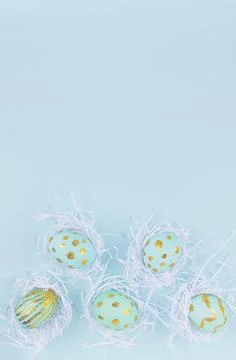 Festive easter background - blue easter eggs with golden glitter design in wh Stock Photos