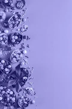 Festive Easter background with chocolate eggs and sweets Stock Photos