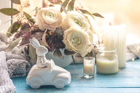 Festive Easter background with decorative ceramic hare and flowers. Stock Photos