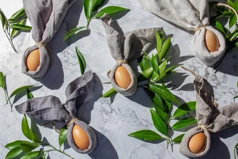 Festive easter background with Easter bunny eggs on linen napkin. Easter deco Stock Photos
