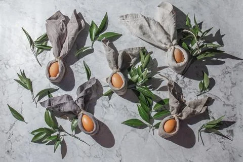 Festive easter background with Easter bunny eggs on linen napkin. Easter deco Stock Photos