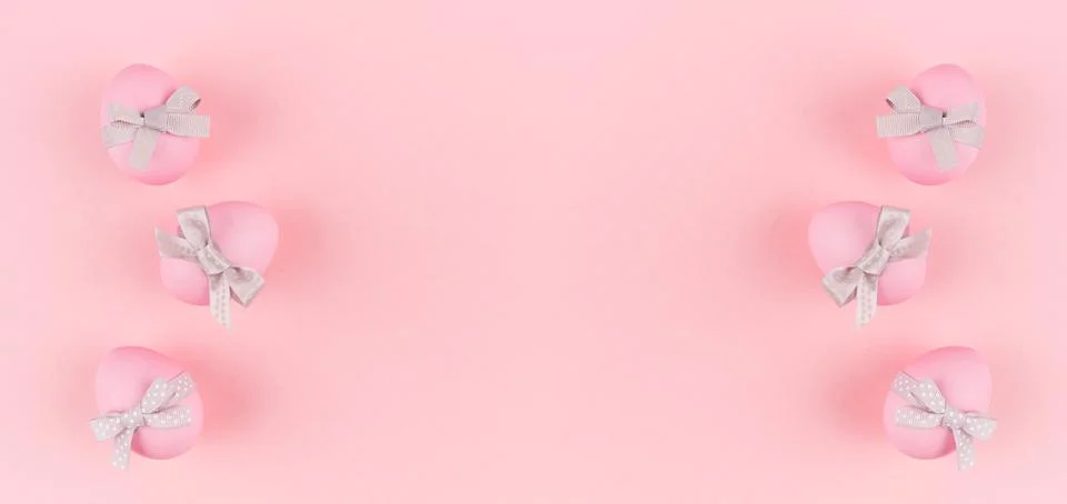 Festive easter banner - pink easter eggs with silver bow as border on pastel  Stock Photos