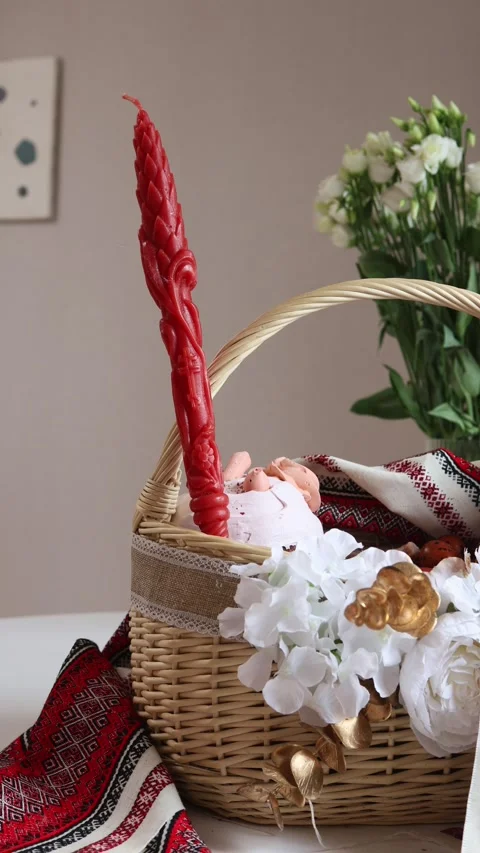 A festive Easter basket with a bright red candle placed in the center Stock Footage 306152204