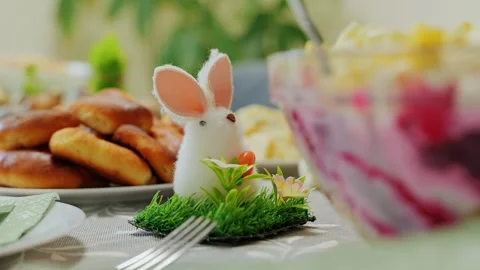 Festive Easter bunny decor on European holiday table set for family meal Stock Footage 327771846