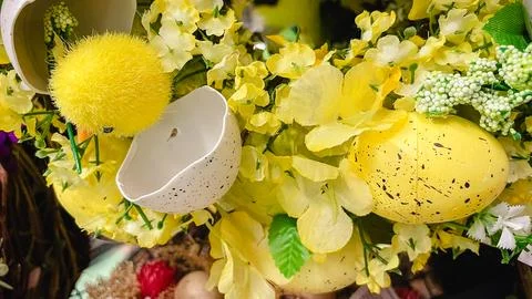 Festive Easter composition with a cute yellow chick, white eggshells and br.. Stock Photos