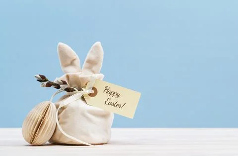 Festive Easter concept with gift bag and egg Stock Photos