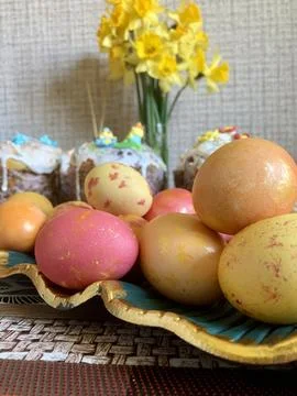 Festive Easter eggs in various colors are arranged on a decorative plate with 스톡 사진