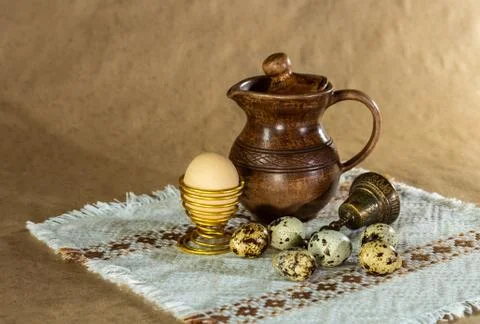 Festive Easter still life with eggs and earthenware jug. Blank for postcards. Stock Photos