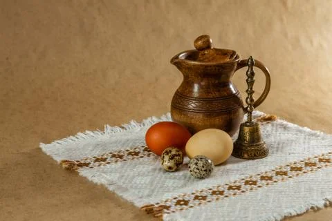 Festive Easter still life with eggs and earthenware jug. Blank for postcards. Stock Photos