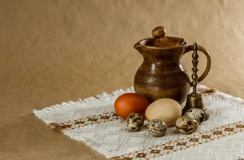 Festive Easter still life with eggs and earthenware jug. Blank for postcards. Stock Photos