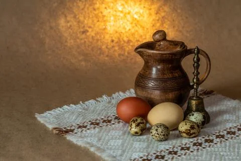 Festive Easter still life with eggs and earthenware jug. Blank for postcards. Stock Photos