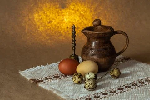Festive Easter still life with eggs and earthenware jug. Blank for postcards. Stock Photos