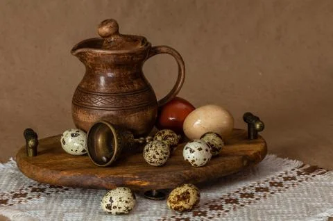 Festive Easter still life with eggs and earthenware jug. Blank for postcards. Stock Photos