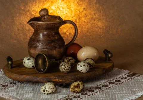 Festive Easter still life with eggs and earthenware jug. Blank for postcards. Stock Photos