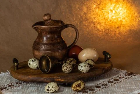 Festive Easter still life with eggs and earthenware jug. Blank for postcards. Stock Photos