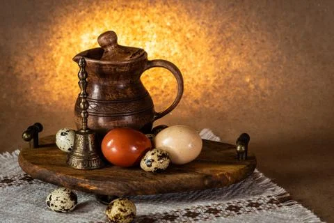 Festive Easter still life with eggs and earthenware jug. Blank for postcards. Stock Photos