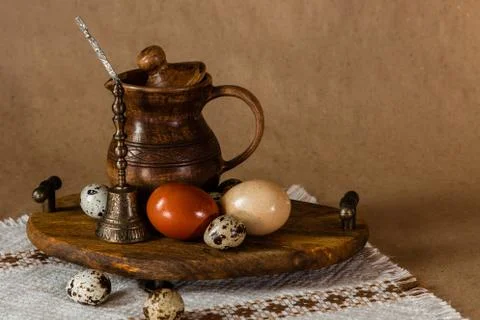 Festive Easter still life with eggs and earthenware jug. Blank for postcards. Stock Photos