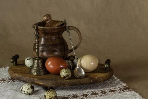 Festive Easter still life with eggs and earthenware jug. Blank for postcards. Stock Photos