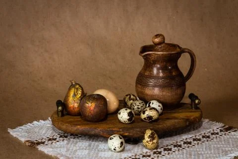Festive Easter still life with eggs and earthenware jug. Blank for cards. Stock Photos