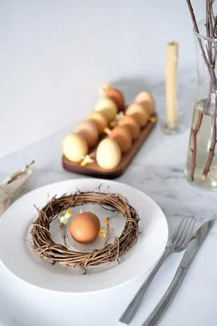 Festive Easter table setting with Easter bunny made of linen napkin and yellow Stock Photos