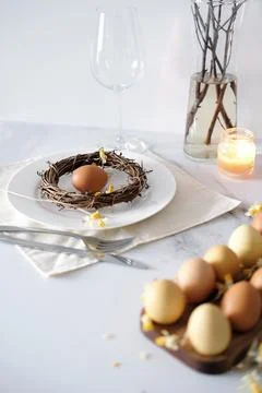 Festive Easter table setting with Easter bunny made of linen napkin and yellow Stock Photos