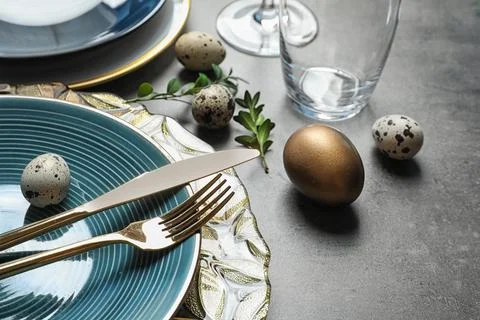 Festive Easter table setting with eggs on color background Stock Photos