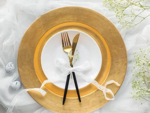 Festive Easter table setting with eggs and flowers on white background Stock Photos