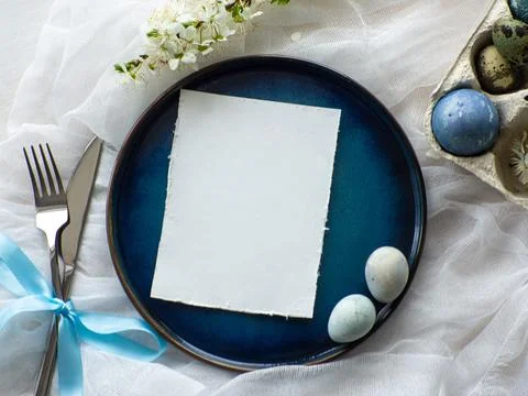 Festive Easter table setting with eggs and flowers on white background Stock Photos