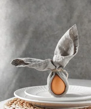 Festive Easter table setting. Funny Easter bunny made of egg and linen napk.. Stock Photos