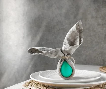 Festive Easter table setting. Funny Easter bunny made of green egg and linen  Stock Photos