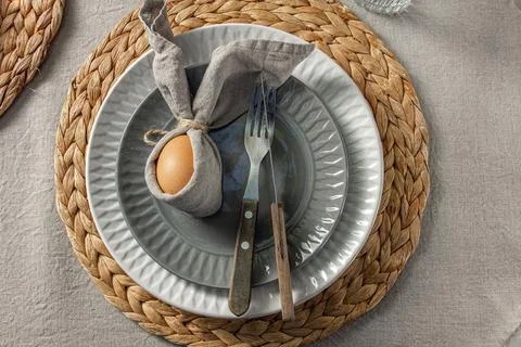 Festive Easter table setting. Funny Easter bunny made of egg and linen napkin Stock Photos