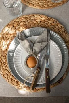 Festive Easter table setting. Funny Easter bunny made of egg and linen napkin Stock Photos