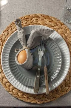 Festive Easter table setting. Funny Easter bunny made of egg and linen napkin Stock Photos