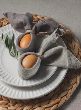 Festive Easter table setting. Funny Easter bunny made of eggs and linen napki Stock Photos